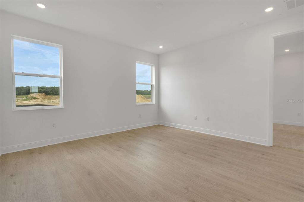1018 Swamp Chestnut Loop Lady Lake, FL 32159 - Photo 19 of 35 an empty room with windows
