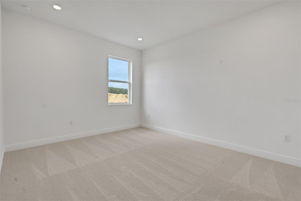 1018 Swamp Chestnut Loop Lady Lake, FL 32159 - Photo 21 of 35 an empty room with a window
