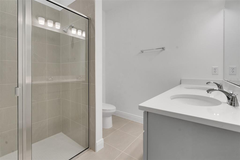 1018 Swamp Chestnut Loop Lady Lake, FL 32159 - Photo 23 of 35 a bathroom with a sink toilet and shower