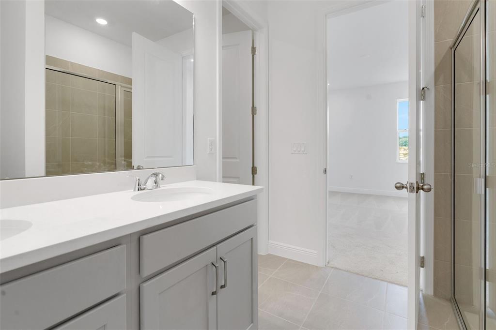 1018 Swamp Chestnut Loop Lady Lake, FL 32159 - Photo 24 of 35 a bathroom with a sink and a mirror