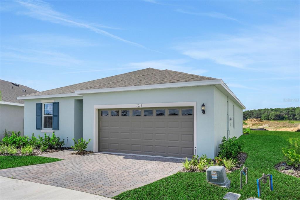 1018 Swamp Chestnut Loop Lady Lake, FL 32159 - Photo 3 of 35 a front view of house with yard