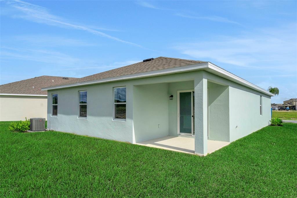 1018 Swamp Chestnut Loop Lady Lake, FL 32159 - Photo 5 of 35 a view of a house with a backyard