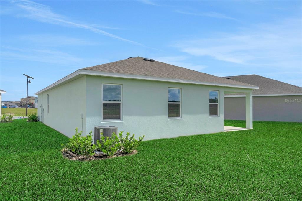 1018 Swamp Chestnut Loop Lady Lake, FL 32159 - Photo 7 of 35 a house that is sitting in middle of the grass