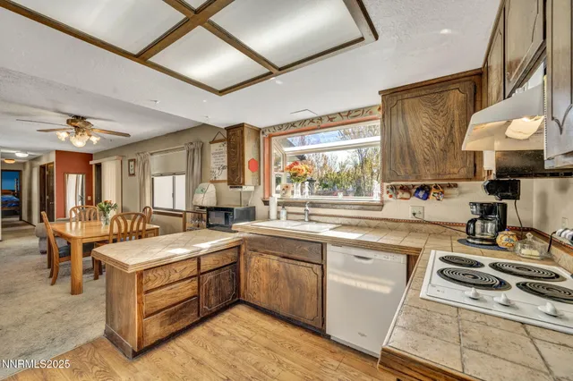 a kitchen with a sink stove and wooden cabinets