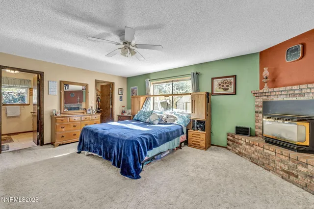 a living room with a bed furniture and a flat screen tv