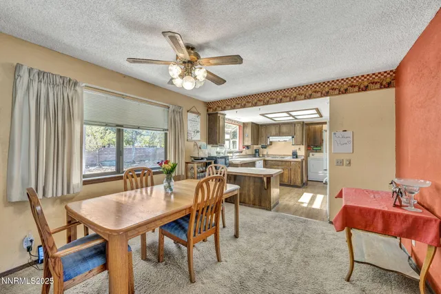 a dining room with furniture a window and a chandelier