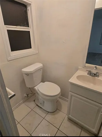 a white toilet sitting next to a bathroom sink