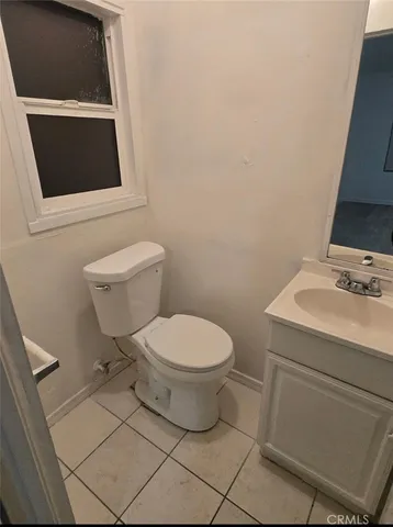 a white toilet sitting next to a bathroom sink