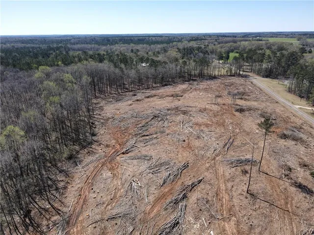 a view of a yard with wooden fence