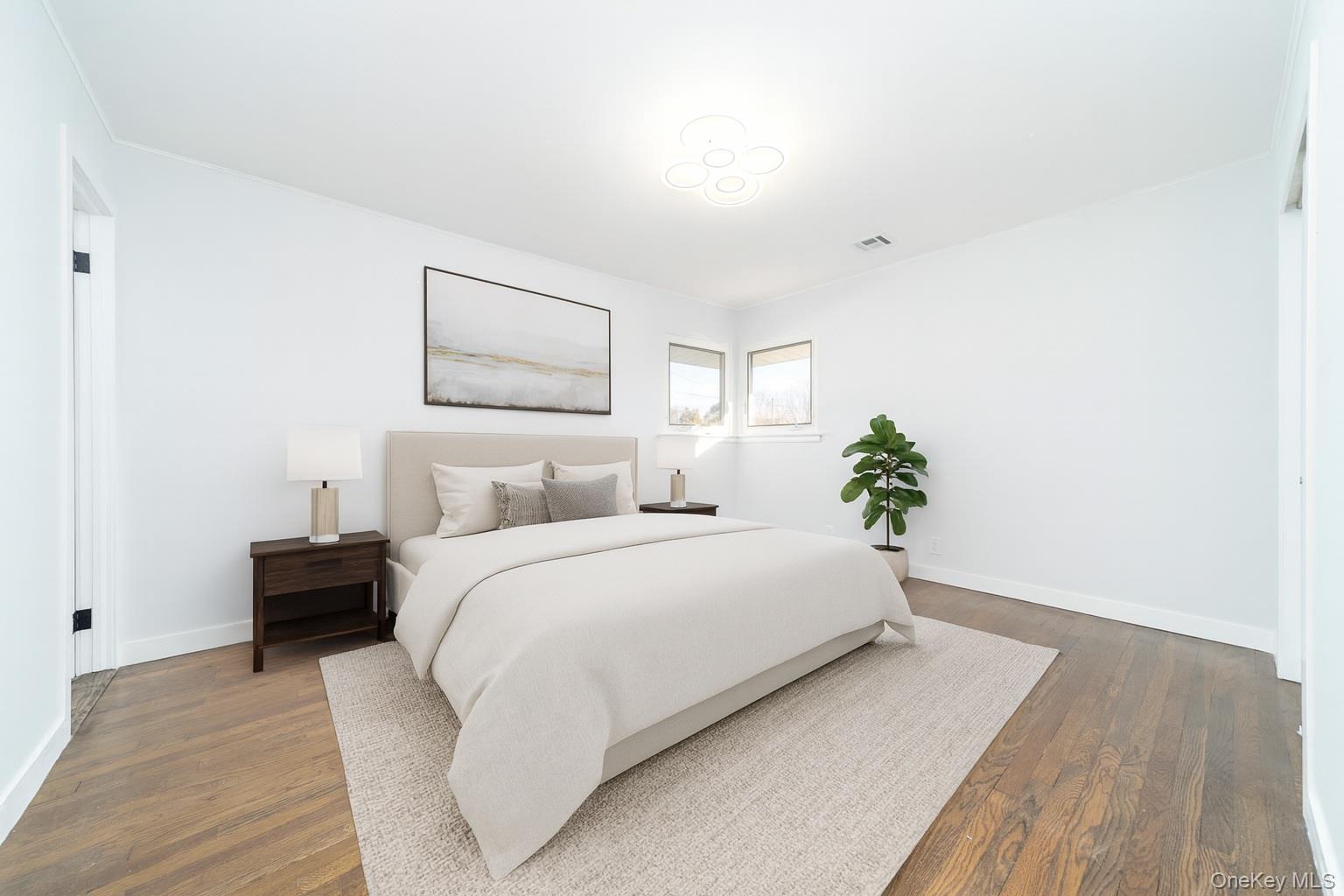 8 Spector Lane Plainview, NY 11803 - Photo 7 of 15 a spacious bedroom with a bed and a painting on the wall