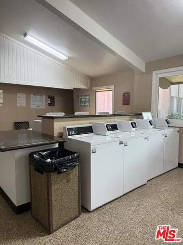 a kitchen with stainless steel appliances granite countertop a sink and a stove