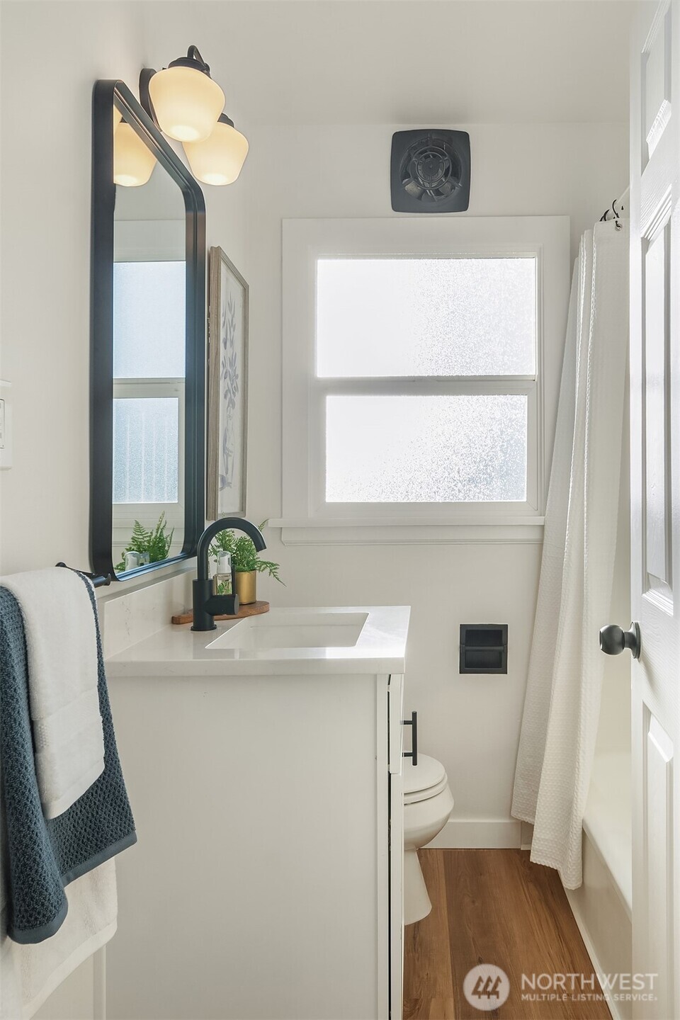 2222 North 29th Street Tacoma, WA 98403 - Photo 17 of 26 a bathroom with a sink a toilet and a mirror