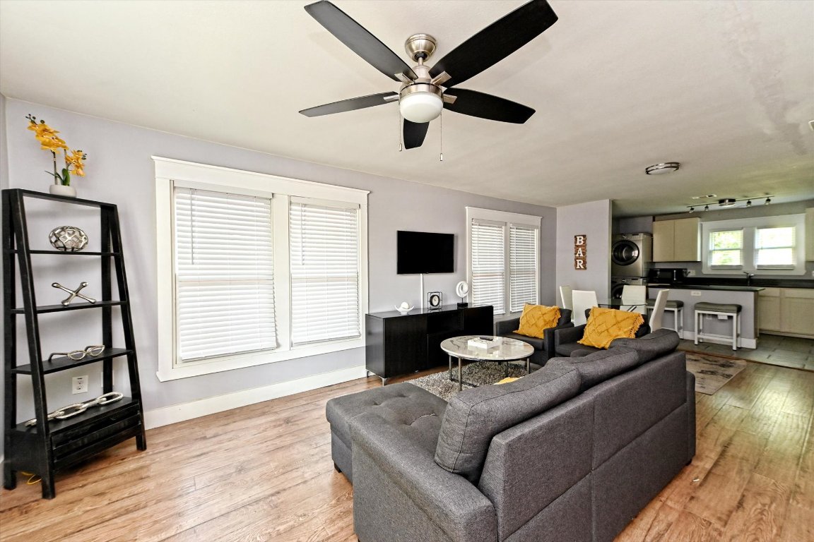 a living room with fireplace furniture and a wooden floor