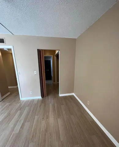 a view of room with wooden floor