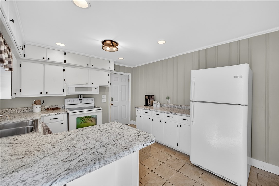 310 Gracie Street Seneca, SC 29678 - Photo 12 of 34 Bright and functional kitchen featuring white cabinetry and tile flooring.