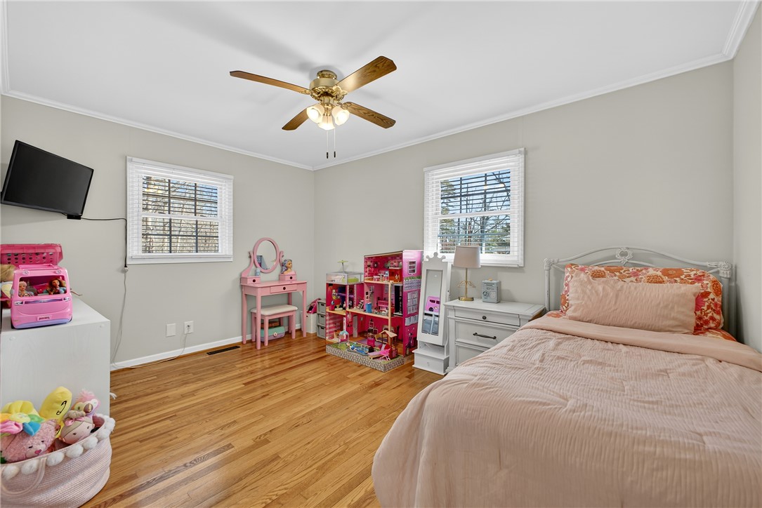 310 Gracie Street Seneca, SC 29678 - Photo 20 of 34 This spacious bedroom features ample natural light and beautiful hardwood flooring.