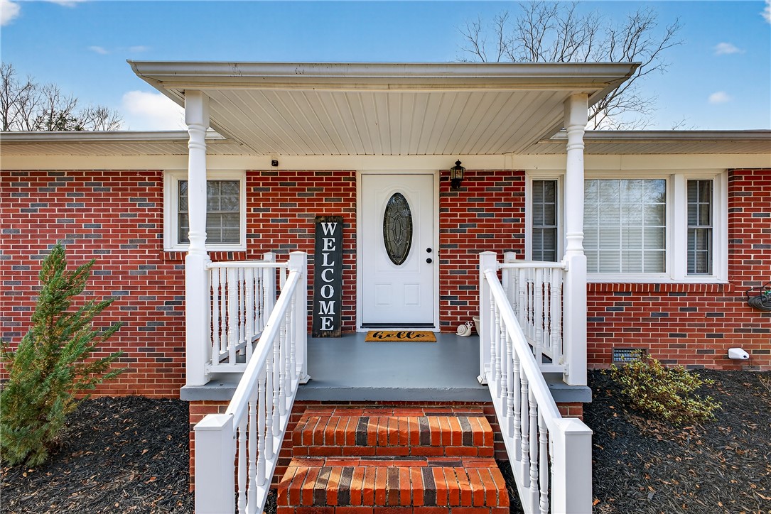 310 Gracie Street Seneca, SC 29678 - Photo 2 of 34 This classic brick residence features a welcoming covered front porch, perfect for greeting guests.