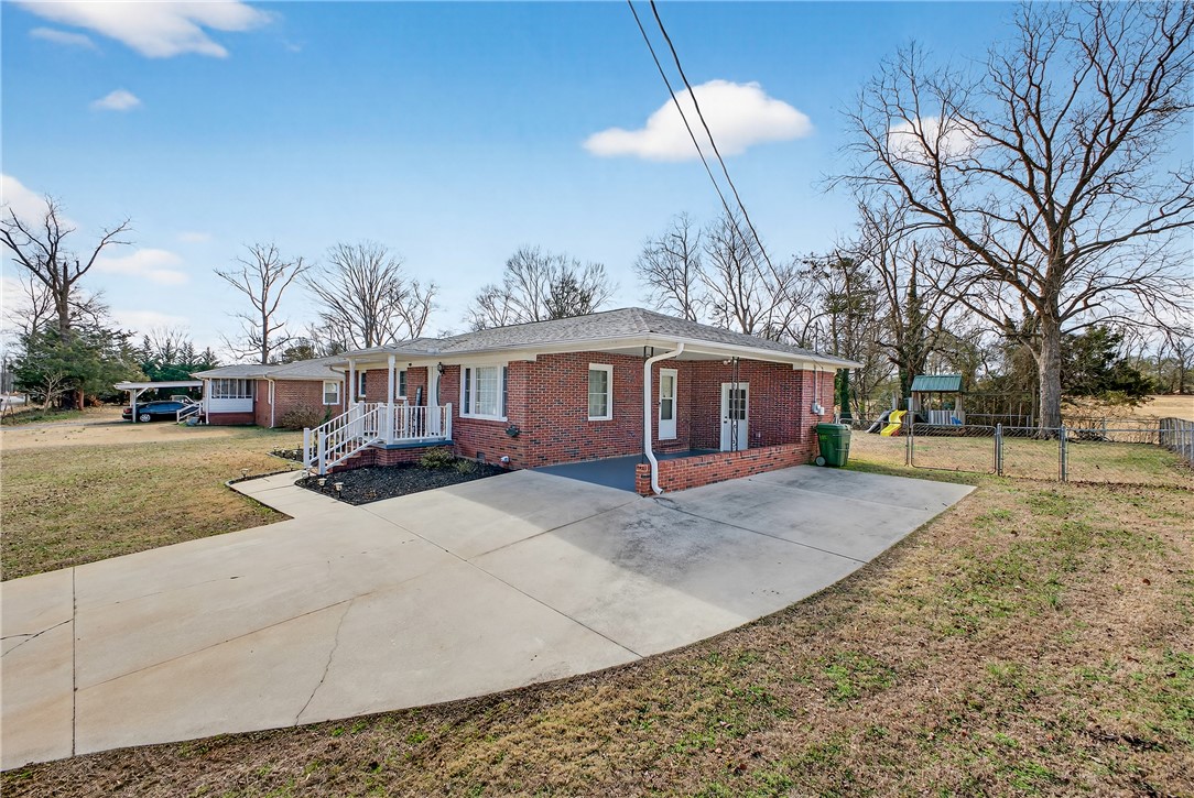 310 Gracie Street Seneca, SC 29678 - Photo 22 of 34 This classic brick residence features a concrete driveway and an expansive fenced yard.