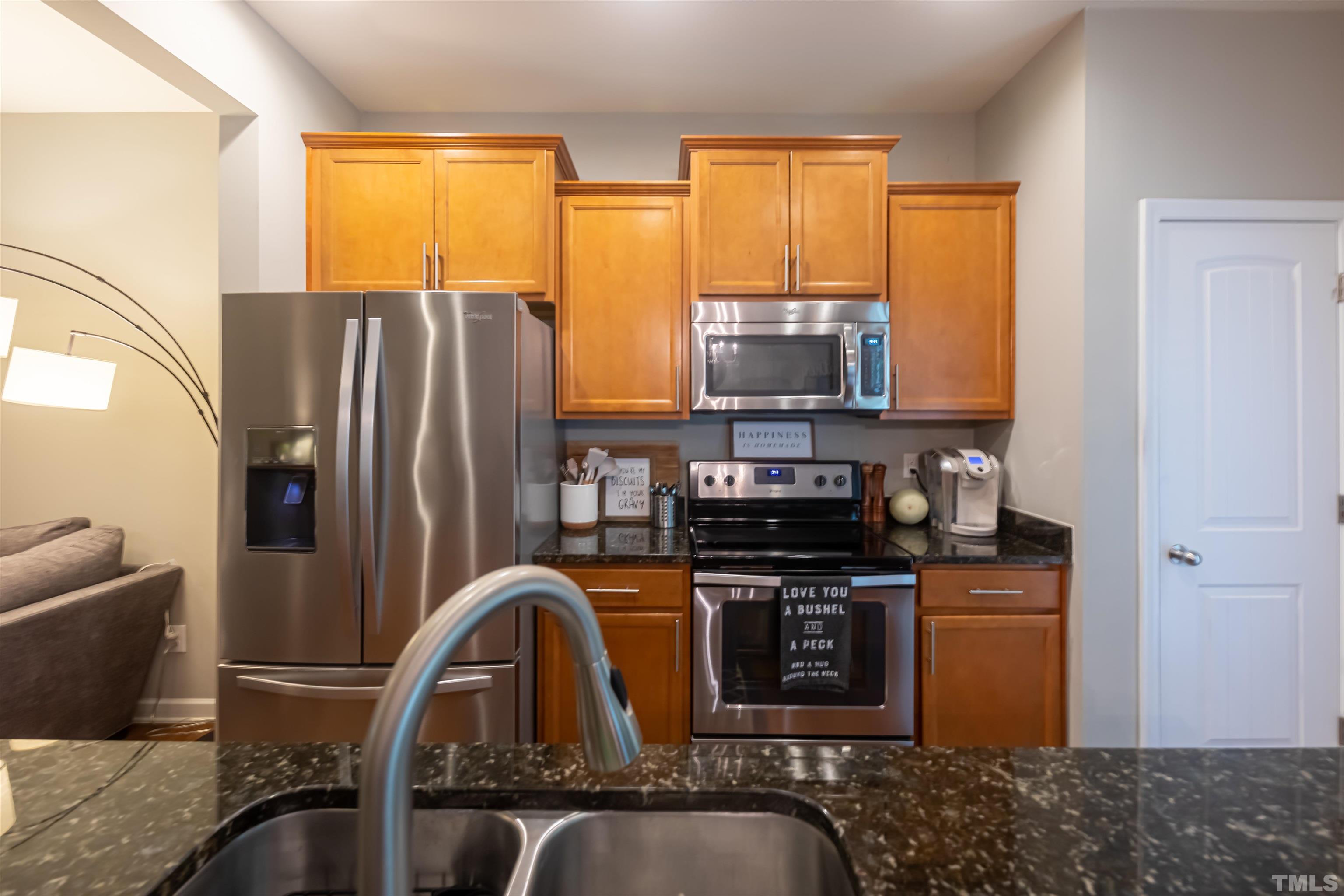 1427 Chatuga Way Wake Forest, NC 27587 - Photo 11 of 36 a kitchen with stainless steel appliances granite countertop a refrigerator a stove top oven a sink and dishwasher