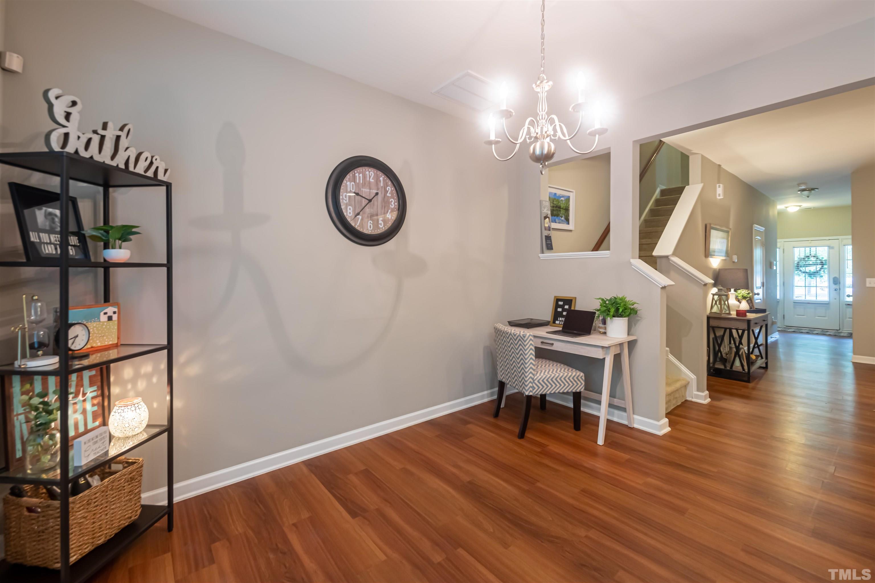 1427 Chatuga Way Wake Forest, NC 27587 - Photo 13 of 36 a view of a dining room with furniture a chandelier and wooden floor