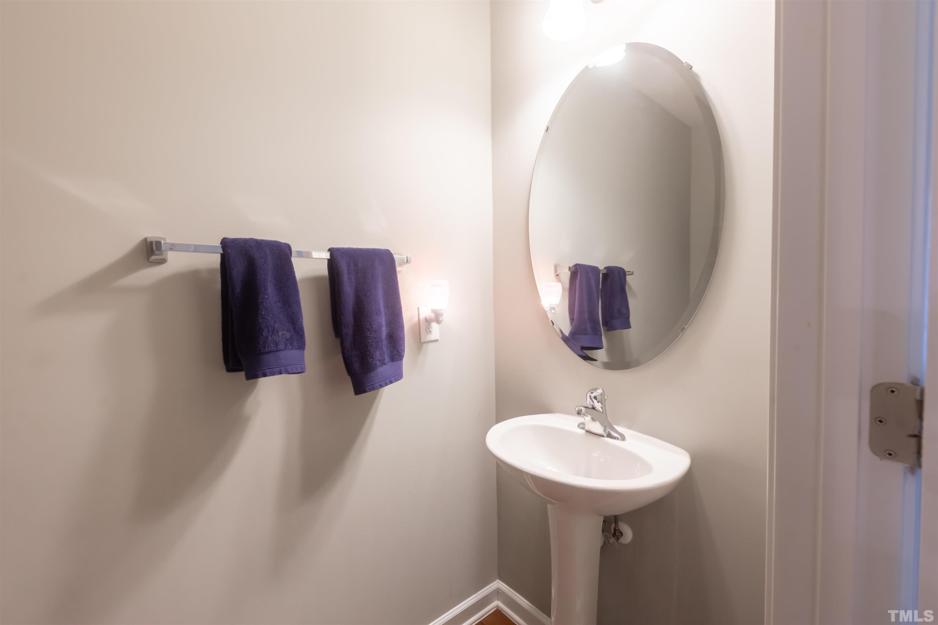 1427 Chatuga Way Wake Forest, NC 27587 - Photo 16 of 36 a bathroom with a sink and mirror