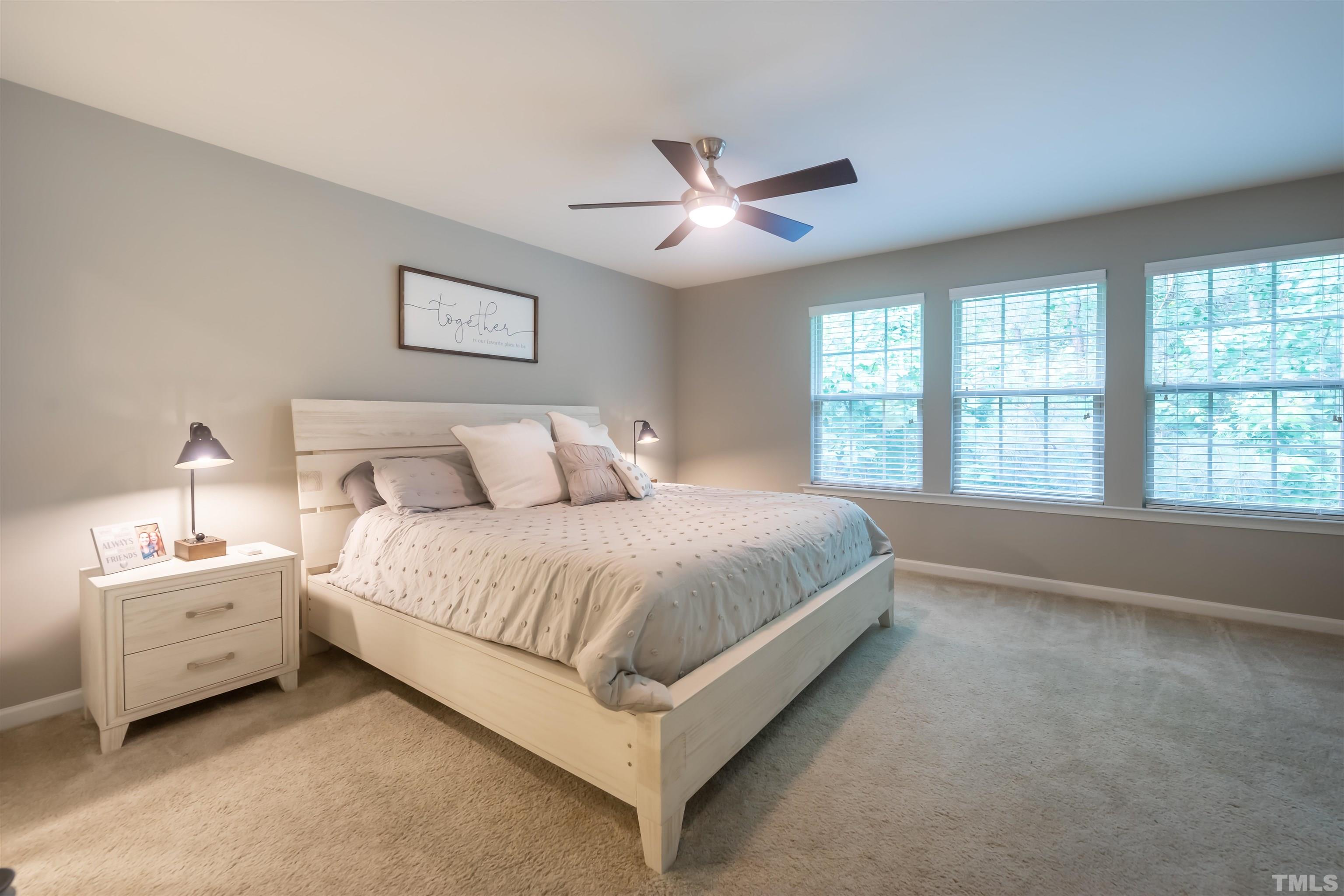 1427 Chatuga Way Wake Forest, NC 27587 - Photo 18 of 36 a spacious bedroom with a bed and a large window