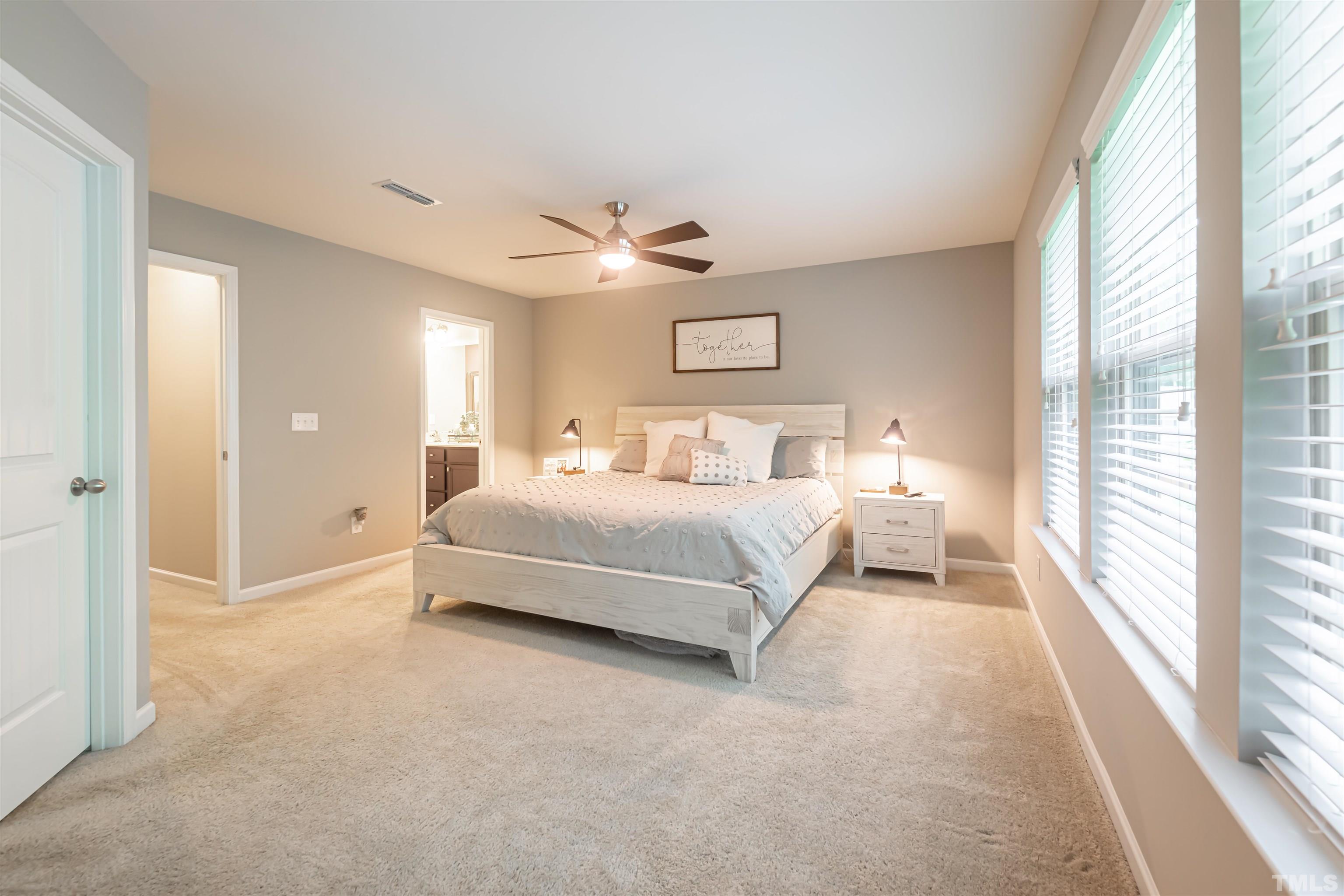 1427 Chatuga Way Wake Forest, NC 27587 - Photo 19 of 36 a bedroom with a large bed and a chandelier