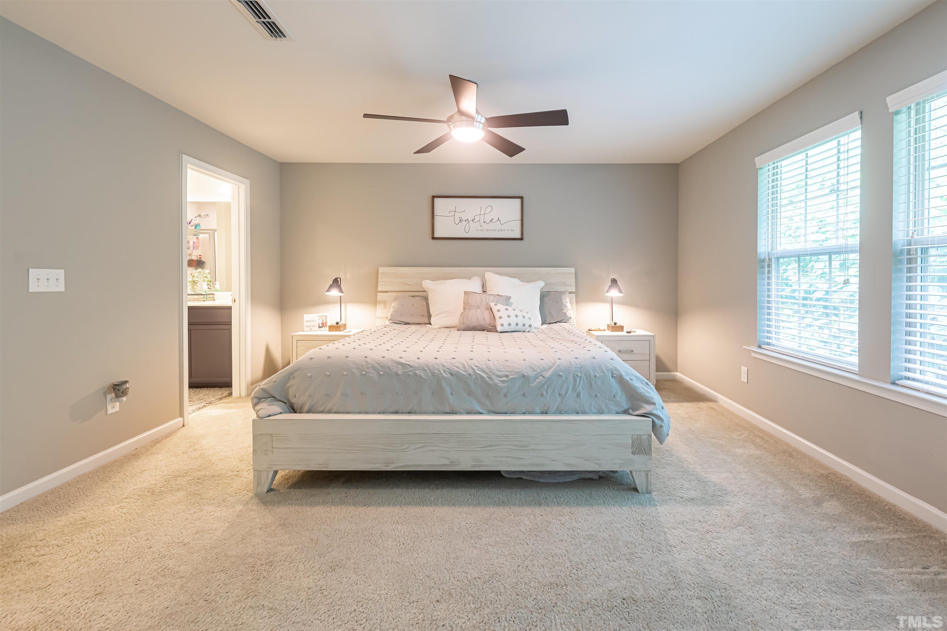 1427 Chatuga Way Wake Forest, NC 27587 - Photo 20 of 36 a bedroom with a large bed and a large window