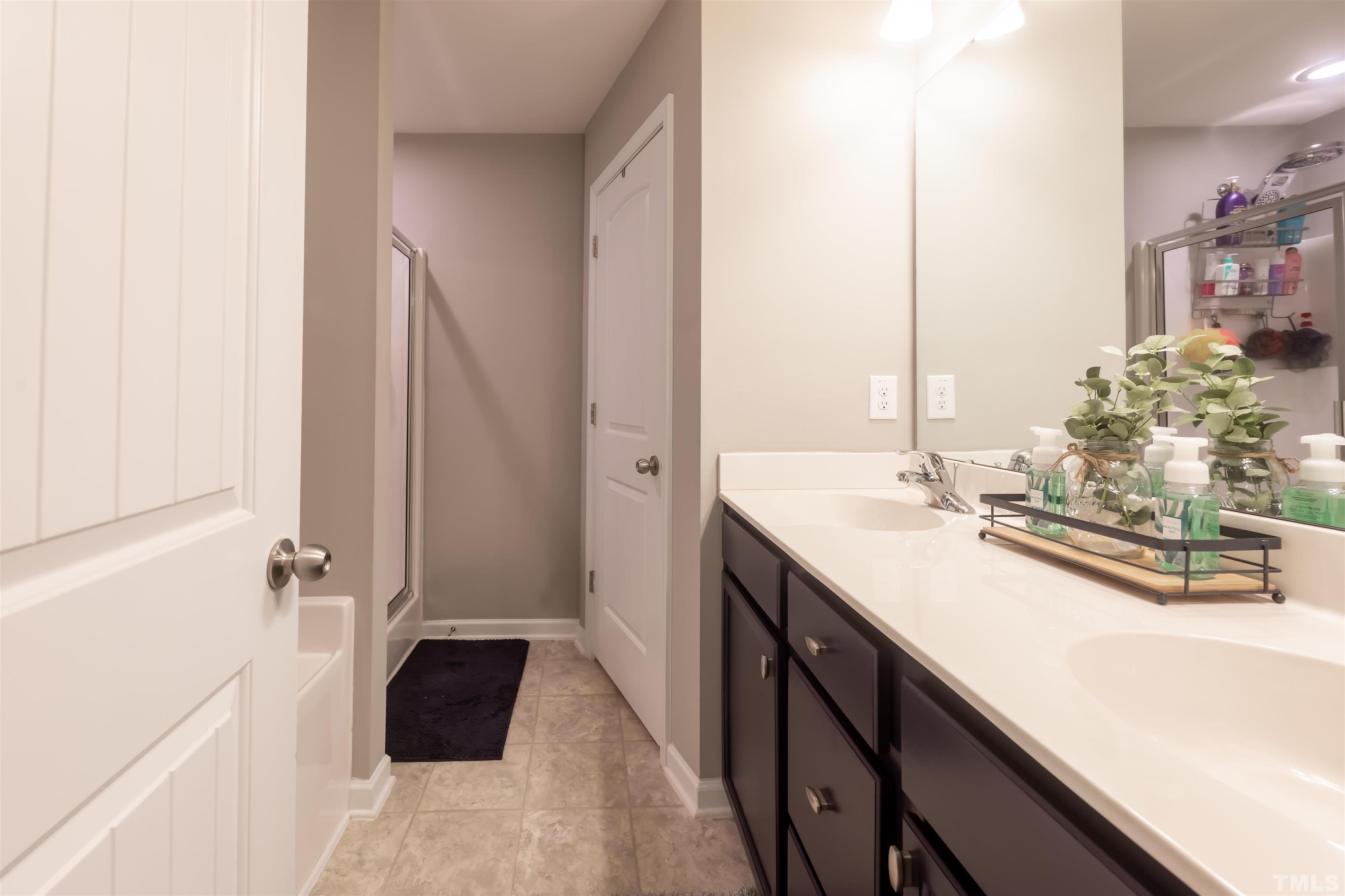 1427 Chatuga Way Wake Forest, NC 27587 - Photo 23 of 36 a bathroom with a double vanity sink and a mirror