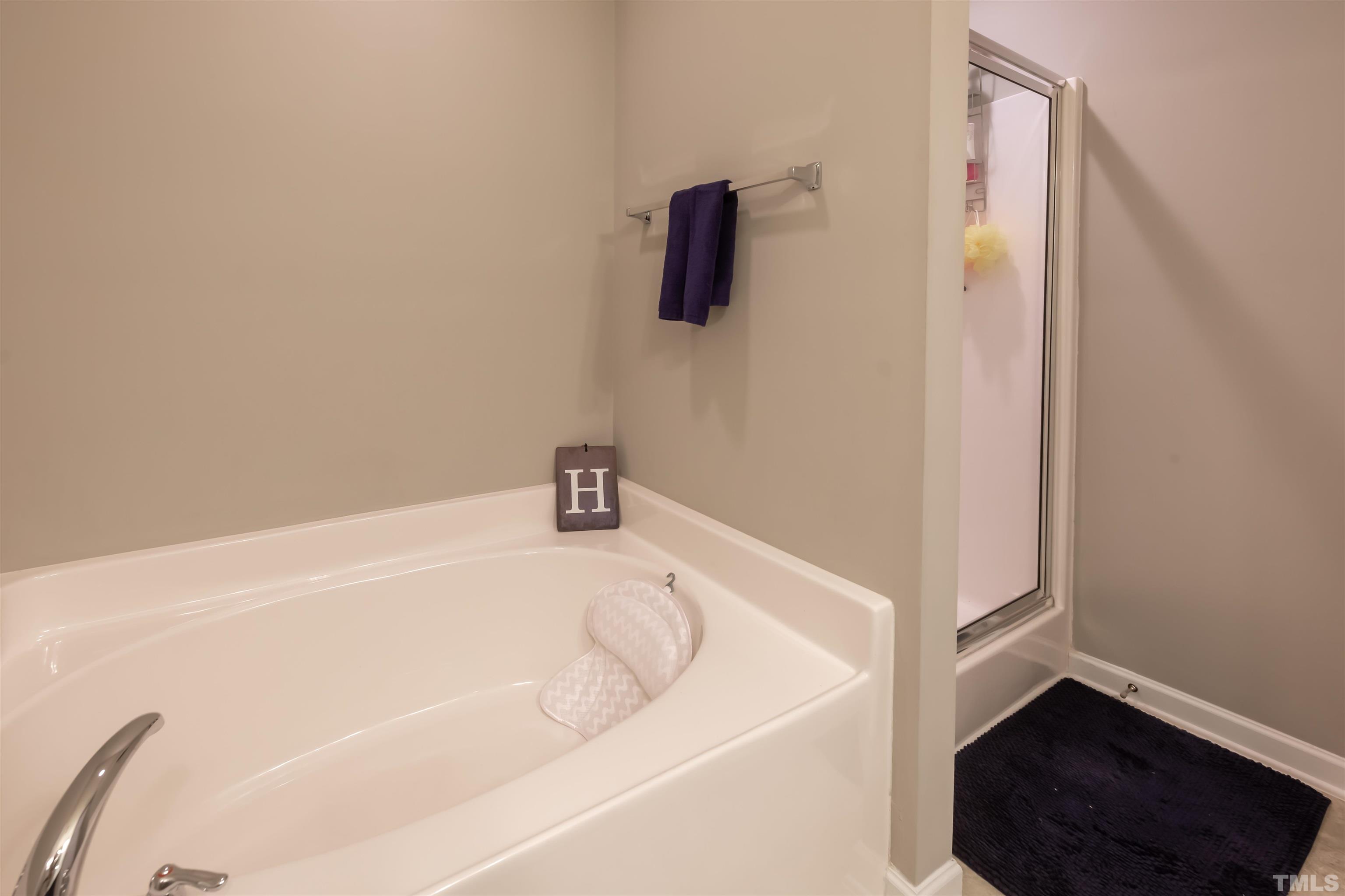 1427 Chatuga Way Wake Forest, NC 27587 - Photo 24 of 36 a white bath tub sitting in a bathroom