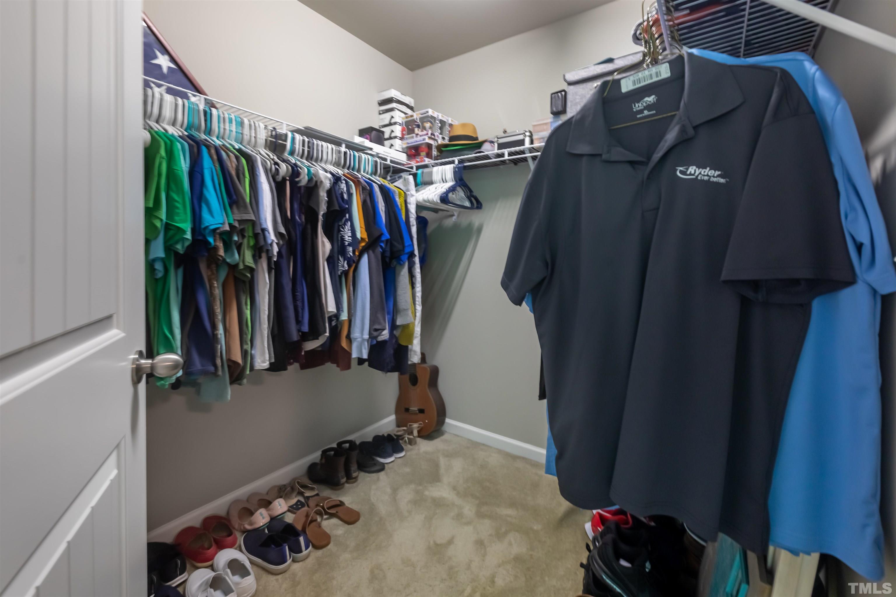 1427 Chatuga Way Wake Forest, NC 27587 - Photo 26 of 36 a view of walk in closet with clothes and shoes