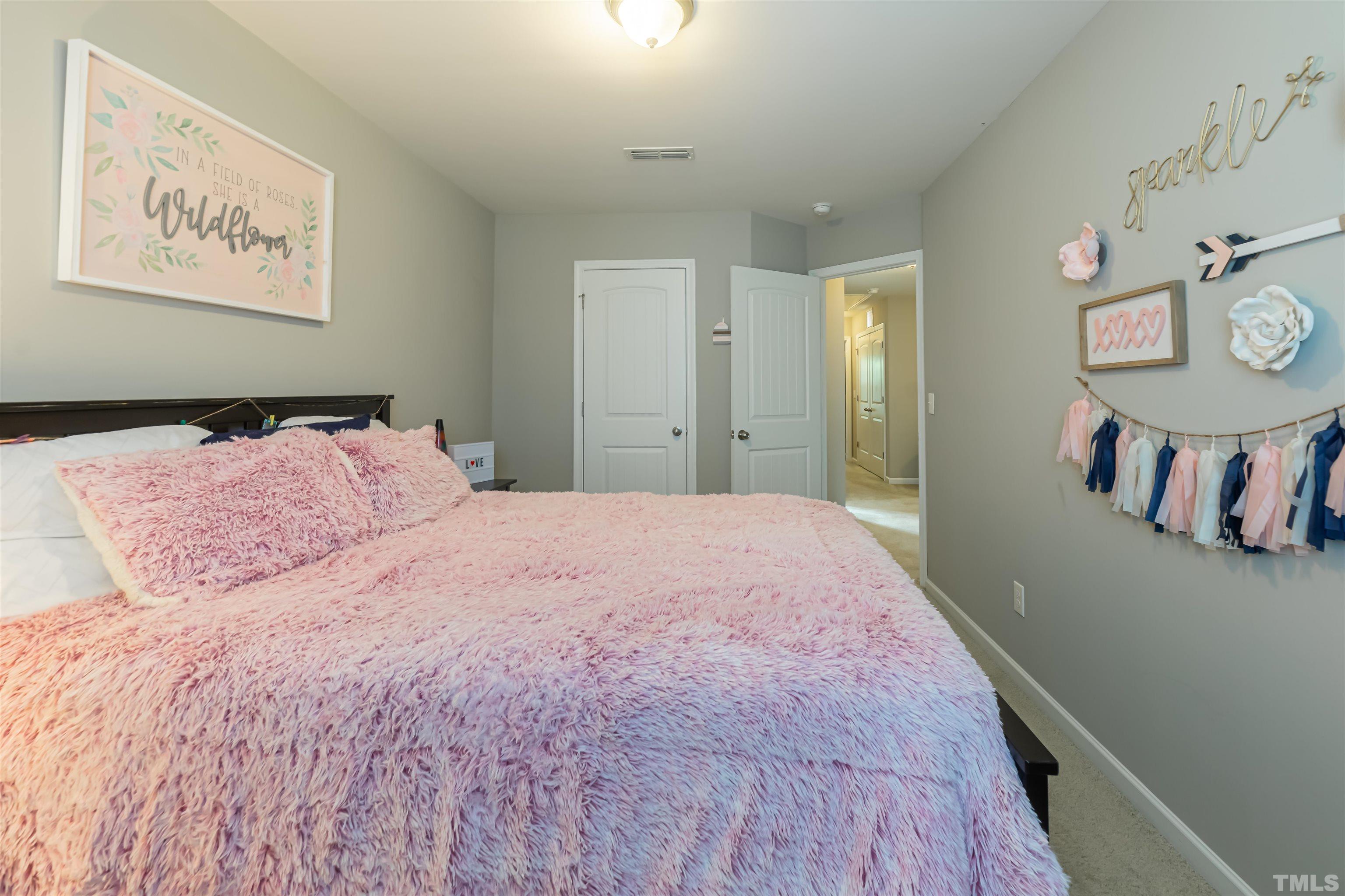 1427 Chatuga Way Wake Forest, NC 27587 - Photo 30 of 36 a bedroom with a bed and painting on the wall