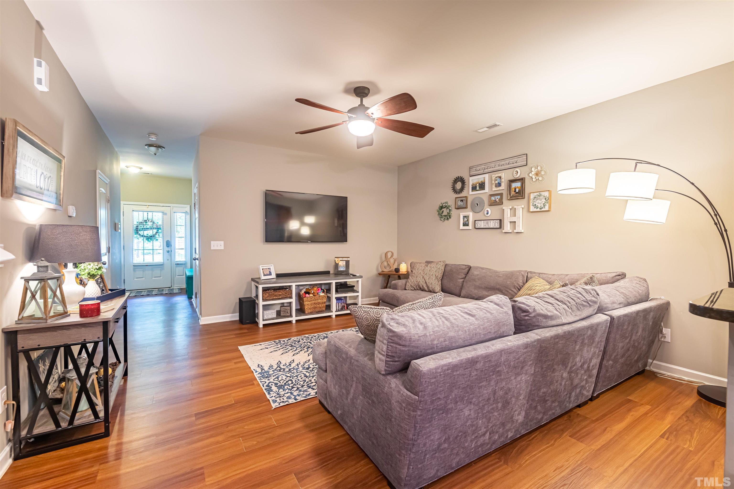 1427 Chatuga Way Wake Forest, NC 27587 - Photo 3 of 36 a living room with furniture and a flat screen tv