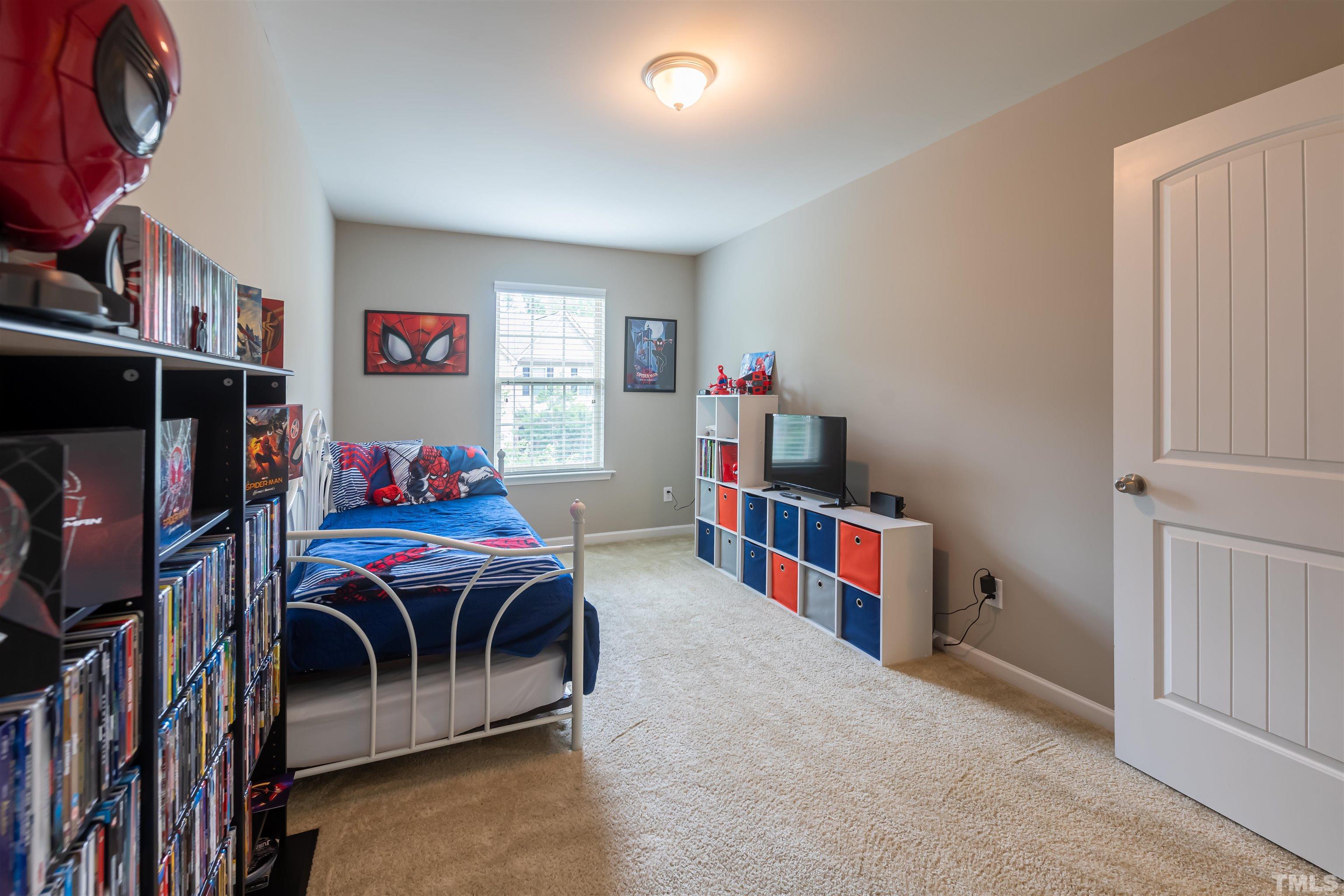 1427 Chatuga Way Wake Forest, NC 27587 - Photo 32 of 36 a bedroom with furniture and a book shelf