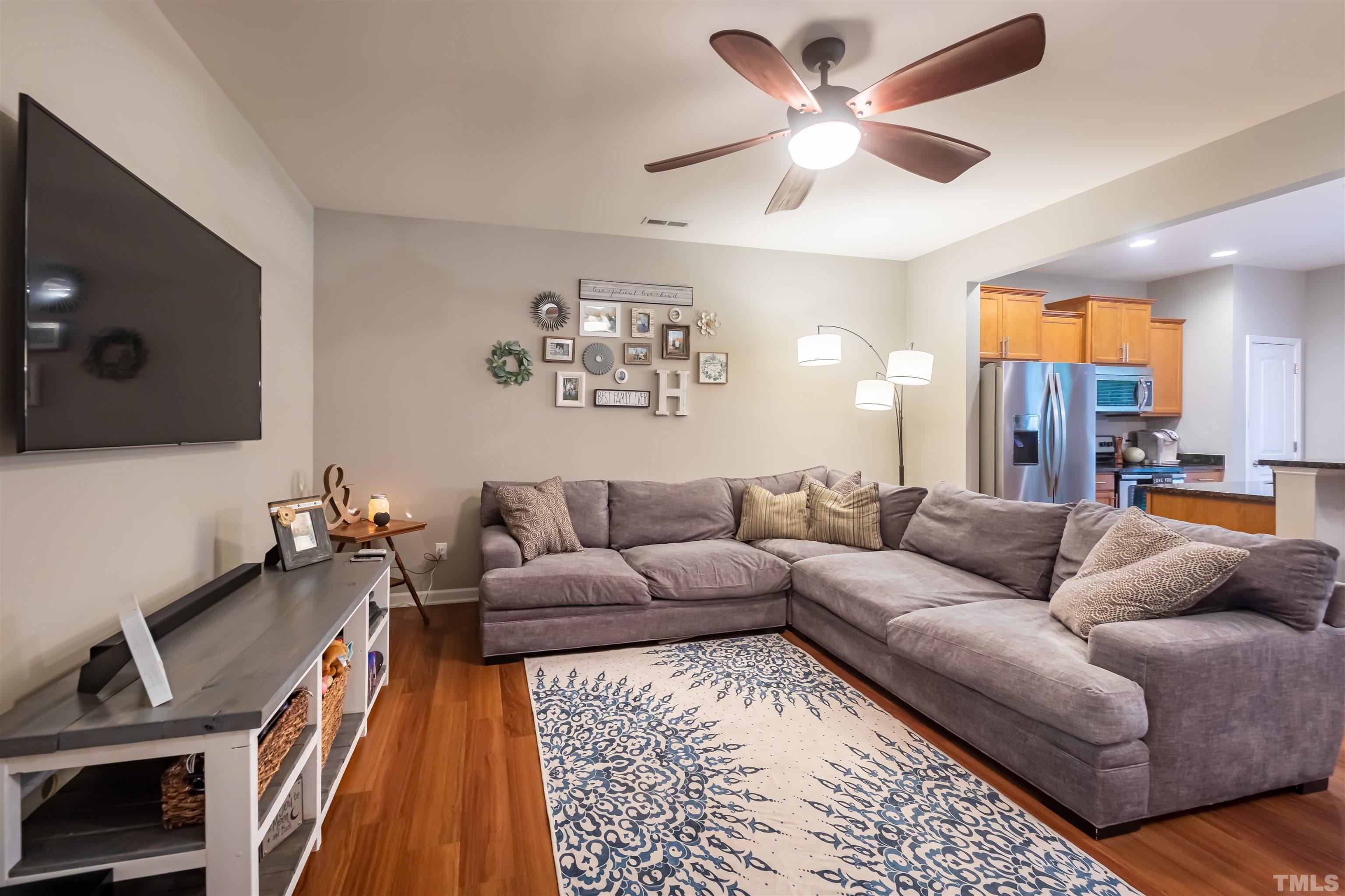 1427 Chatuga Way Wake Forest, NC 27587 - Photo 6 of 36 a living room with furniture and a flat screen tv