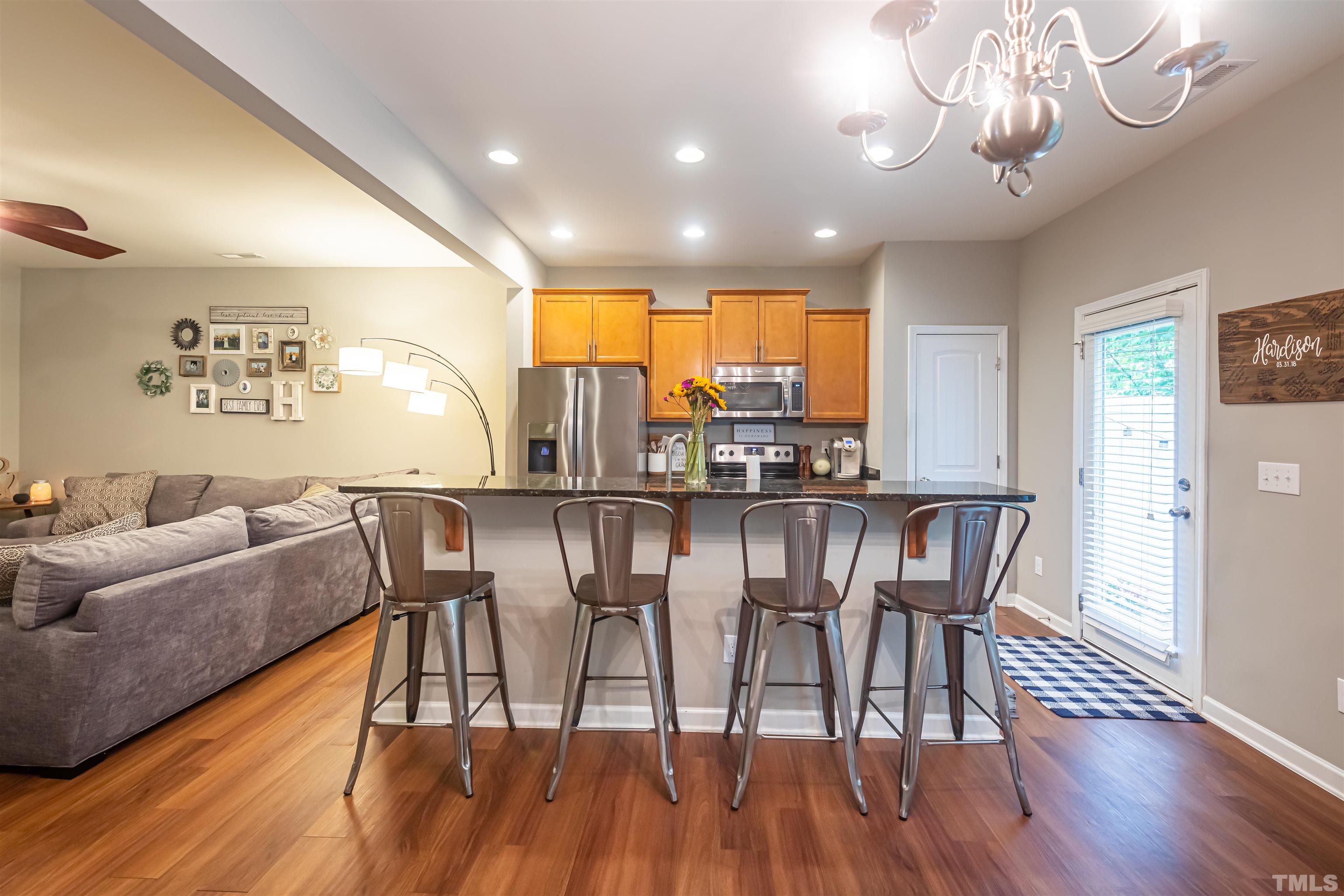 1427 Chatuga Way Wake Forest, NC 27587 - Photo 8 of 36 a view of a dining room with furniture wooden floor and chandelier