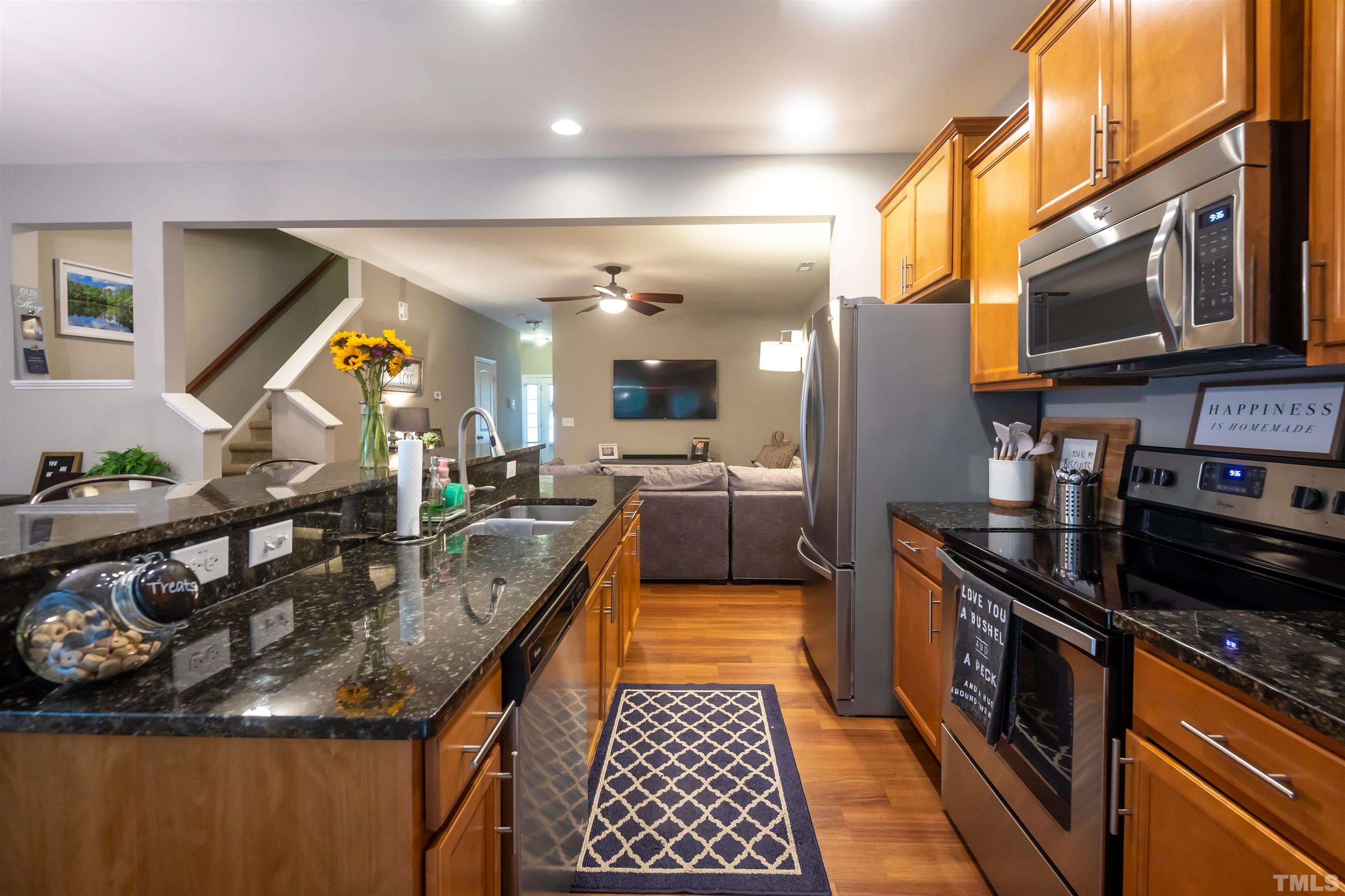 1427 Chatuga Way Wake Forest, NC 27587 - Photo 10 of 36 a kitchen with stainless steel appliances granite countertop a sink and a refrigerator