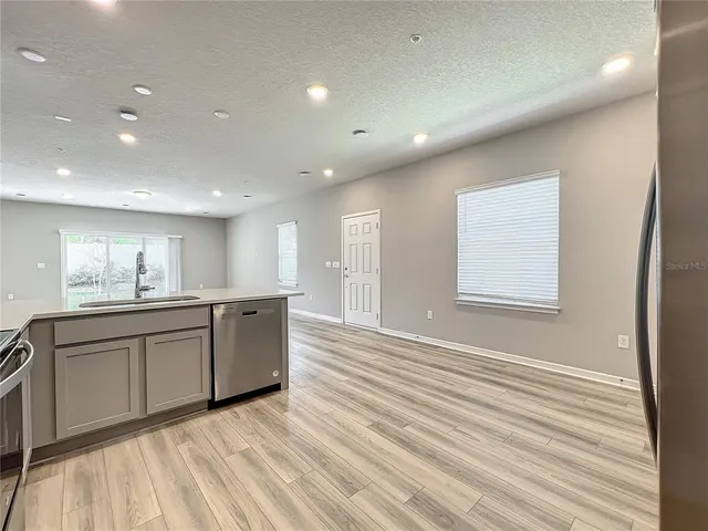 a kitchen with stainless steel appliances granite countertop a stove microwave and sink