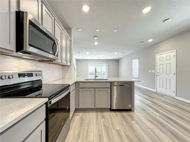 a kitchen with a refrigerator and a microwave
