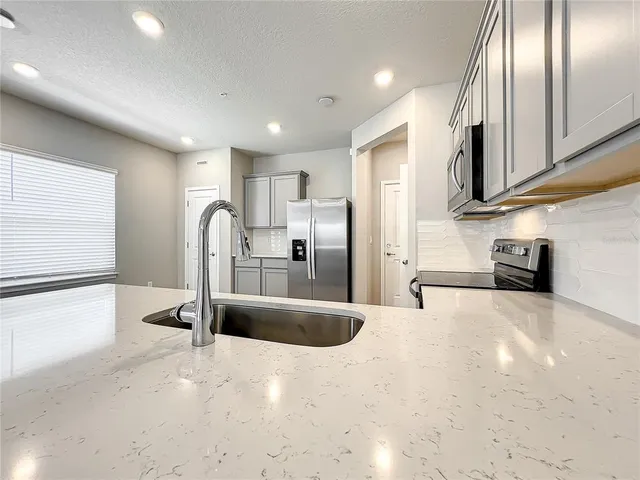 a view of kitchen with wooden floor and electronic appliances