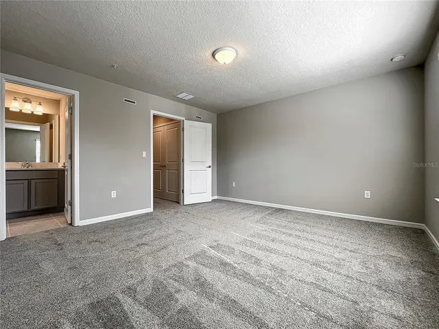 a view of a house with backyard and a tree