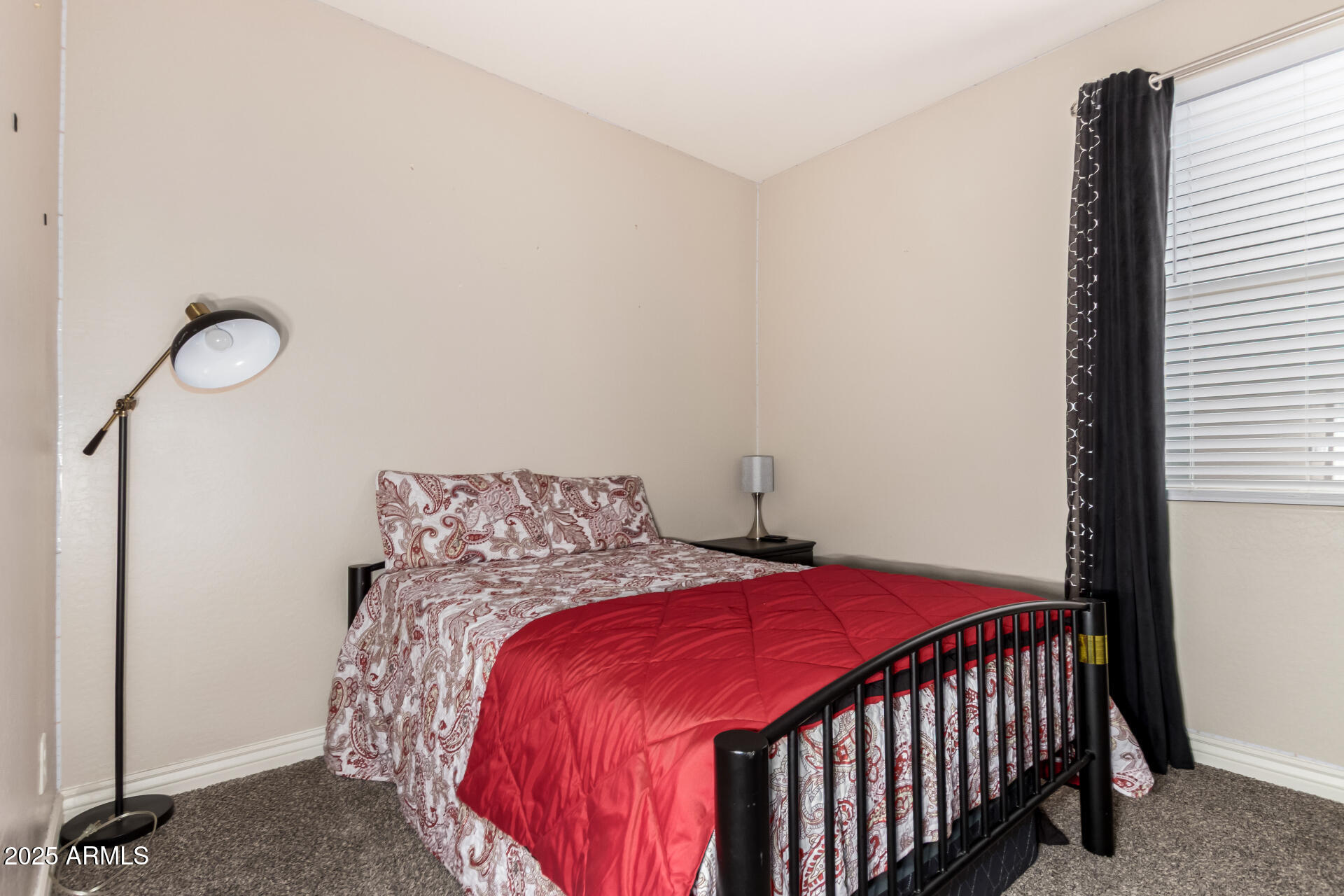 10637 West Crown King Road Tolleson, AZ 85353 - Photo 13 of 19 a bedroom with a bed and a window