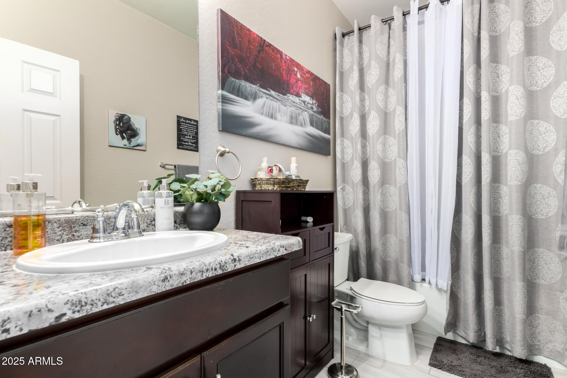 10637 West Crown King Road Tolleson, AZ 85353 - Photo 14 of 19 a bathroom with a granite countertop sink and a mirror with toilet