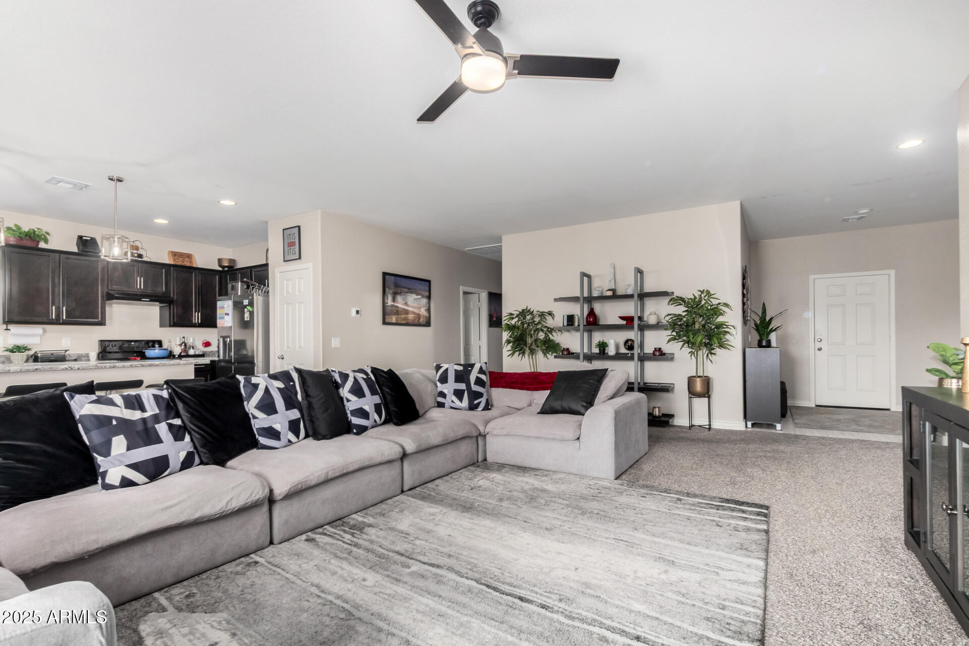 10637 West Crown King Road Tolleson, AZ 85353 - Photo 3 of 19 a view of living room with kitchen island furniture and a chandelier