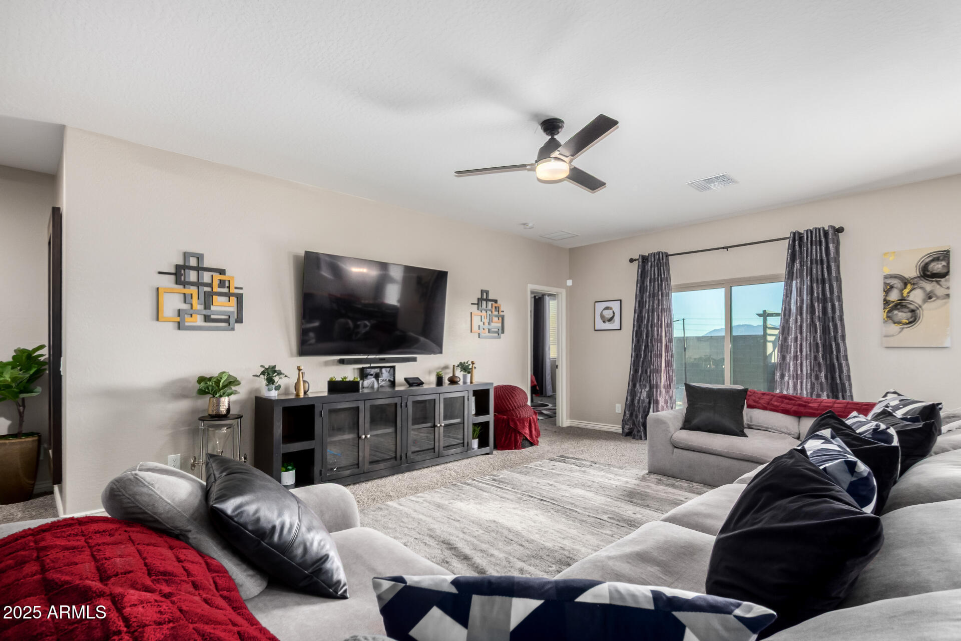 10637 West Crown King Road Tolleson, AZ 85353 - Photo 5 of 19 a living room with furniture and a flat screen tv