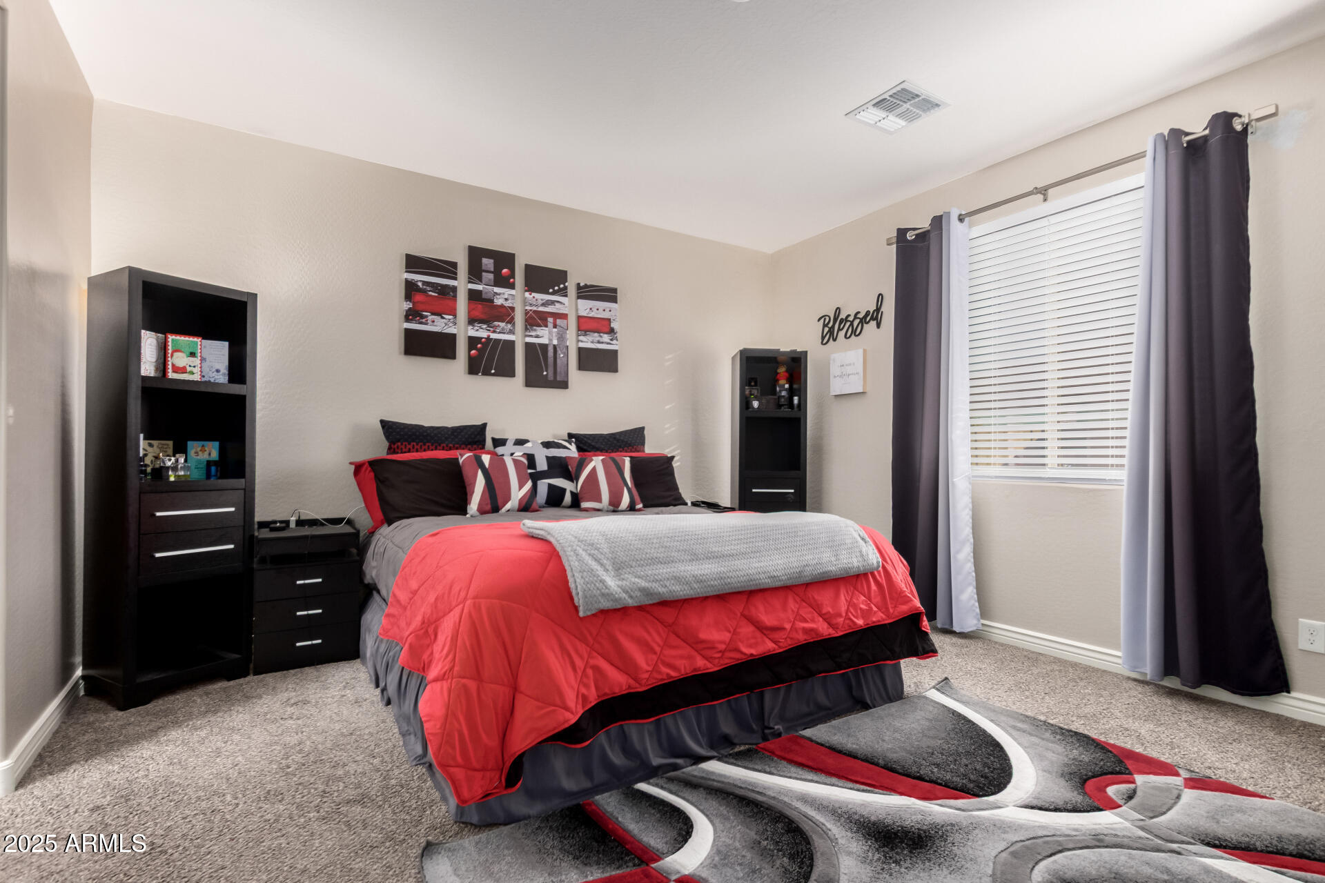 10637 West Crown King Road Tolleson, AZ 85353 - Photo 8 of 19 a bed sitting in a bedroom next to a window