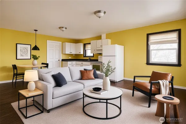 a living room with furniture and a view of kitchen