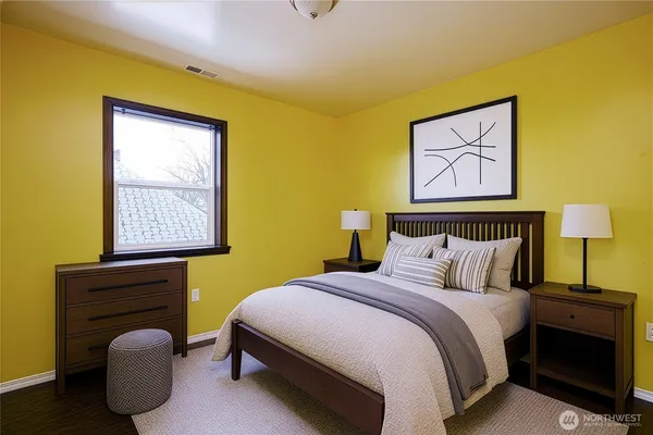 a bedroom with a bed and a window