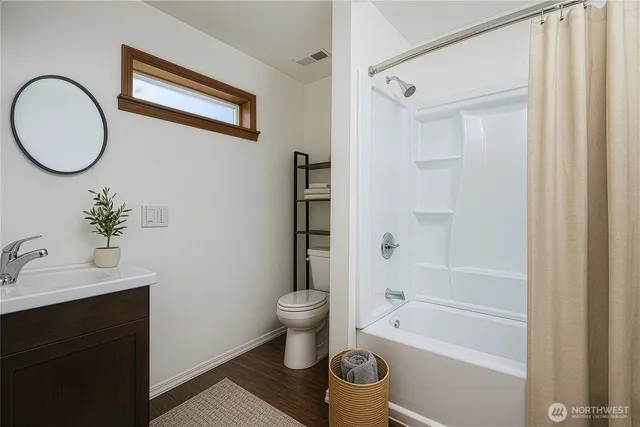 a bathroom with a toilet sink and a mirror