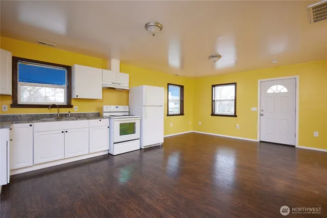 a view of a kitchen with stove and cabinets
